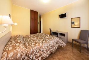 Postel nebo postele na pokoji v ubytování Hotel Aurelia