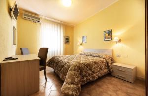 Postel nebo postele na pokoji v ubytování Hotel Aurelia