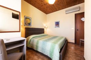 Postel nebo postele na pokoji v ubytování Hotel Aurelia