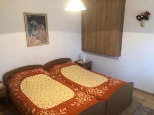 a bedroom with a bed with a red blanket at Bed & Breakfast Borka in Opatija