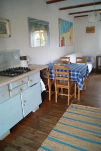 a kitchen and dining room with a table and a stove at Białka in Białogóra