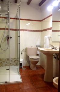 a bathroom with a toilet and a sink and a shower at Casa Cayo in Potes