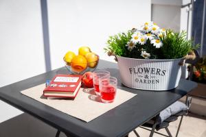 a table with a pot of flowers and a bowl of fruit at TorreParadiso Holidays in Polignano a Mare +14 photos
