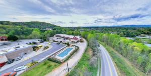 an overhead view of a road with a house and a pool at Dahlonega Mountain Inn in Dahlonega