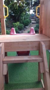 a wooden bench sitting on top of green grass at Villa Verde Apartments and Rooms in Premantura