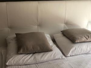 a bed with two pillows on top of it at Komfortowe Apartamenty in Okuninka