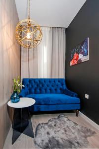 a blue couch in a living room with a table at Deluxe Studio G 12 in Rovinj