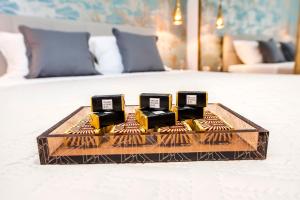 a tray with three candles on top of a bed at Deluxe Studio G 12 in Rovinj