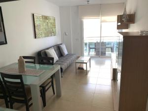 a living room with a couch and a table at Apartamento Calafell playa in Calafell