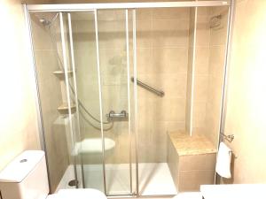 a shower stall in a bathroom with a toilet at Apartamento Calafell playa in Calafell +21 photos