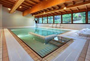 a large swimming pool in a large room at Grand Hotel Presolana in Castione della Presolana