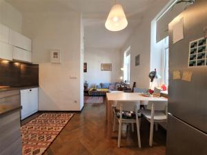 a kitchen and living room with a table and a dining room at Cosy Ljubljana Loft in Ljubljana