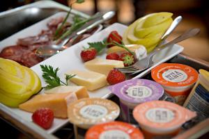 a plate of cheese and fruit on a table at The Jug And Bottle in Heswall