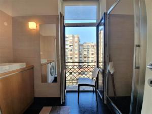 a bathroom with a balcony with a view of a city at Cosy Ljubljana Loft in Ljubljana +17 photos