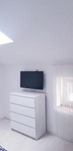 a white room with a tv on top of a dresser at David 3 in Pula