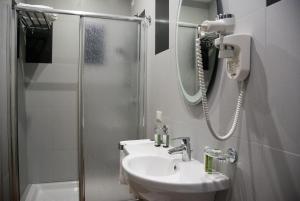 a bathroom with a sink and a shower at Il Portico Luxury B&B in Cassano delle Murge