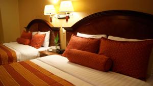 En eller flere senge i et værelse på Hotel Monteolivos