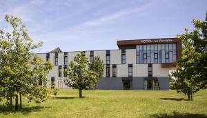 a building with trees in front of it at Hôtel la Verriaire - The Originals in La Verrie