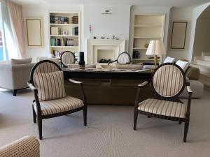 a living room with a large desk with chairs at Hotel Miramare & Spa in Sestri Levante