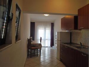 a kitchen with a table and a dining room at Apartments Sveti Anton in Orebić