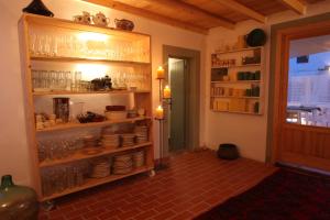 a kitchen with a shelf full of food at Hostal Juanita in Ibiza Town