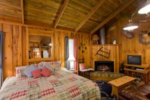 a bedroom with a bed and a fireplace at Panther Valley Ranch in Morning Star