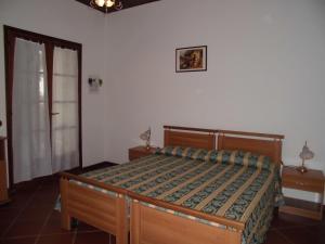 a bedroom with a wooden bed in a room at B&B Il Vigneto in Capoterra