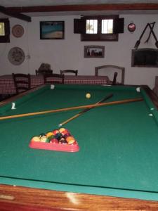 a pool table with two cue sticks and balls on it at B&B Il Vigneto in Capoterra