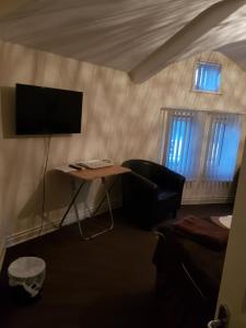 A television and/or entertainment center at The Crescent Budget Hotel 