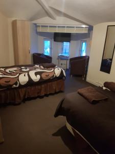 A bed or beds in a room at The Crescent Budget Hotel 