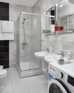 a bathroom with a shower and a sink and a toilet at Moodeight Apartments in Skopje