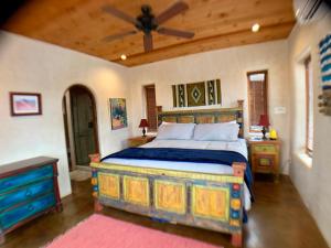a bedroom with a bed and a ceiling fan at The Casita del Lago in Abiquiu