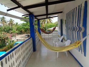 a hammock on the balcony of a house at Cabañas Los Juanchos Coveñas in Coveñas
