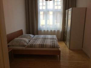 a bedroom with a bed with a window and a dresser at holiday-apartments in Bremen