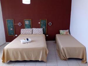 two beds sitting next to each other in a room at Petit Hotel Panambi in Puerto Iguazú +8 photos