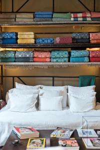 a bed with white pillows in a room at Casa das Janelas com Vista in Lisbon