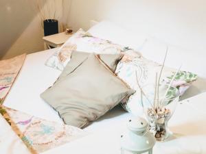 a bed with pillows and a vase on a table at Apartment Paolo in Senj