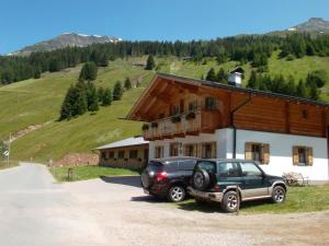 a black car parked in front of a building at Riepleralm in Matrei in Osttirol