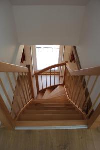 a wooden staircase in a house with a window at Ferienwohnung Altstadtidylle 2 in Wernigerode