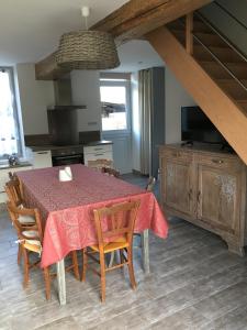 a kitchen with a table with a red table cloth on it at Gîte de la Huppe in Noyers-sur-Cher