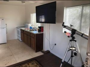 a camera in a kitchen with a television on the wall at Delight's Hot Springs Resort in Tecopa