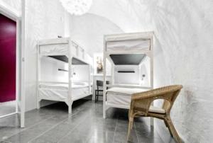 a bedroom with two bunk beds and a chair at Ramilton Old Town Hostel in Stockholm