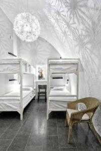 a bedroom with two bunk beds and a chandelier at Ramilton Old Town Hostel in Stockholm