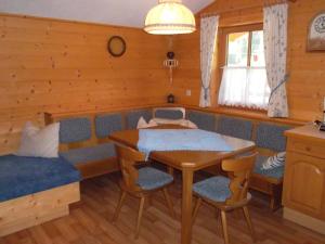 a dining room with a table and a couch at Riepleralm in Matrei in Osttirol