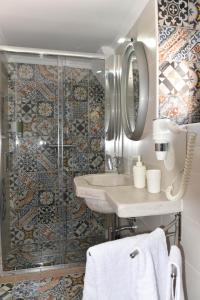 a bathroom with a sink and a shower at Casa Mida - Guest House in Pezze di Greco