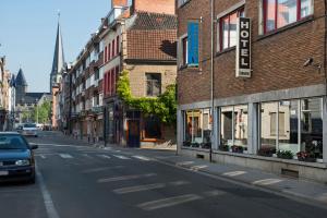 a city street with a car driving down the street at Hotel Cathedral in Ghent