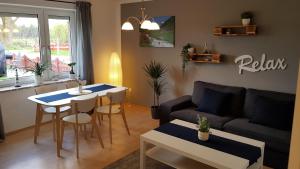 Ferienwohnung am Nord-Ostsee-Kanal في Breiholz: غرفة معيشة مع أريكة وطاولة