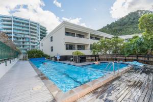 a swimming pool in front of a building at Ocean Retreat 228 in Mount Maunganui