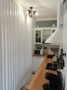 a kitchen with white vertical blinds in a kitchen at PÁLFFY in Bratislava