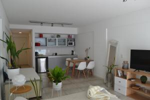 sala de estar con cocina y mesa con plantas en APT New Studio Palermo en Buenos Aires